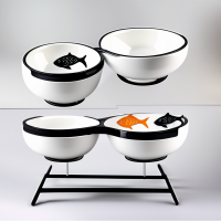 A set of ceramic food bowls on stands, 2 bowls included: 1 with a paw pattern, 2 with a fish pattern. There is an individual black stand for each of the bowls.	WB Ozone Bowls Use offers: profitable, easy to wash, safe materials, durable materials