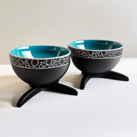 A set of ceramic food bowls on stands, 2 bowls included: 1 with a paw pattern, 2 with a fish pattern. There is an individual black stand for each of the bowls.	WB Ozone Bowls Use offers: profitable, easy to wash, safe materials, durable materials